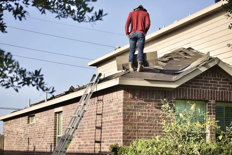 Professional roofer working on a residential roof in River Oaks Condominiums